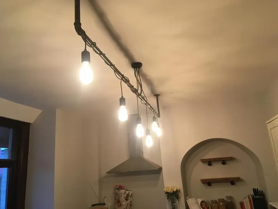 A kitchen with a bunch of lights hanging from the ceiling.